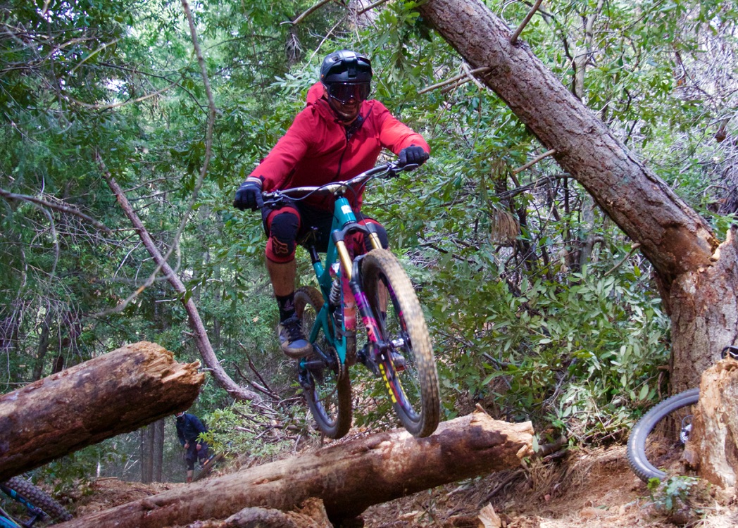 Mountain biker jumping off of log in Georgetown Bike Trail network in California